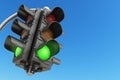 Traffic light with green color on blue sky background. Royalty Free Stock Photo