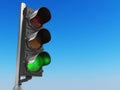 Traffic light with green color on blue sky background. Royalty Free Stock Photo