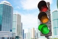 Traffic light with green light on urban skyscrapers city background