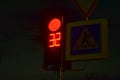 Traffic light at the intersection at night for pedestrians and cars Royalty Free Stock Photo