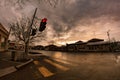Traffic light in little town with the beautiful sunset and dramatic clouds Royalty Free Stock Photo