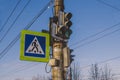 Traffic light with a pedestrian crossing sign against the blue sky Royalty Free Stock Photo