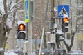 Traffic light for pedestrians with a red light in the shape of a human figure on a pillar in the city Royalty Free Stock Photo