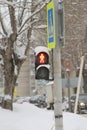 Traffic light for pedestrians with a red light in the shape of a human figure on a pillar in the city Royalty Free Stock Photo