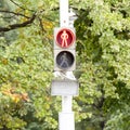 Traffic light with a red signal prohibiting movement of people