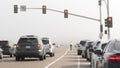 Traffic light semaphore on misty freeway road. Fog on pacific ocean coast highway. California USA.