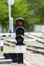 Traffic light shows red signal on railway. station. Royalty Free Stock Photo