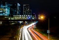Traffic light trails from moving cars on Lamar Street in Austin, texas with buildings in the background