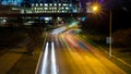 Traffic light trails from moving cars on Lamar Street in Austin, texas with buildings in the background