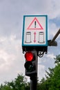 Traffic light with warning sign. Royalty Free Stock Photo
