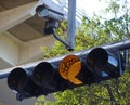 Traffic light in yellow with security cam Royalty Free Stock Photo