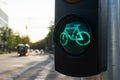 Traffic lights for bicycles on a sunny summer day with blurred city view in a background. Green light for sports concept. Royalty Free Stock Photo