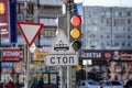 Traffic lights on a busy shopping street with signs showing red and yellow light Royalty Free Stock Photo