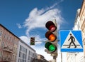 Traffic lights and pedestrian crossing sign in a city Royalty Free Stock Photo