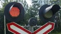 Traffic lights and signs at the railroad crossing. Close-up of an active railroad crossing light Royalty Free Stock Photo