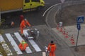 Traffic line painting. Workers are painting white street lines on pedestrian crossing. Road cones with orange and white Royalty Free Stock Photo