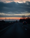 Traffic on the main highway through the landscape of SkÃÂ¥ne Scania in southern Sweden during a winter sunset Royalty Free Stock Photo