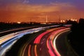 Traffic with motion cars with luminous lines of speed and the evening European city of Frankfurt with beautiful sunset sky, Royalty Free Stock Photo