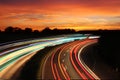 Traffic with motion cars with luminous speed lines and evening sky with beautiful sunset sky, natural landscape Royalty Free Stock Photo