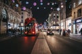 Traffic on New Oxford Street decorated with Christmas Lights, London, UK Royalty Free Stock Photo