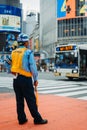 Traffic officer standing on a crossing while a bus pass by in japan Royalty Free Stock Photo