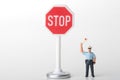 Traffic officer miniature figurine with a stop sign