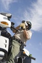 Traffic Officer Sitting On Bike And Monitoring Speed Through Radar Gun Royalty Free Stock Photo
