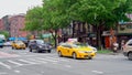 Traffic passing and locals crossing 1st Avenue