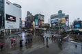 Traffic and people walking on crosswalk with falling rain at Ximending in Taipei, Taiwan. Ximending is the famous fashion, night