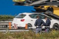 The traffic police check the speed of vehicles on the side of the highway with a speed camera