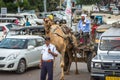 Traffic police officer directing traffic with cars and a Camel pulling cart, Jaipur, India