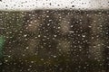 Traffic in rainy day with road view through car window with rain drops. Royalty Free Stock Photo