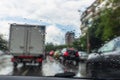 Traffic in rainy day with road view through car window with rain drops, blurry traffic on rainy day Royalty Free Stock Photo