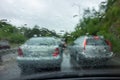 Traffic in rainy day with road view through car window. Slippery road with traffic jam. Dangerous transportation Royalty Free Stock Photo