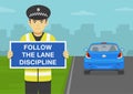 Traffic regulation. Police officer holding warning poster or sign with follow the lane discipline. Royalty Free Stock Photo