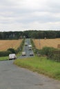 Square bales of hay in a field either side of the main road In Yorkshire UK