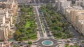 Traffic on a road intersection with roundabout in Barsha Heights and Greens district aerial timelapse.