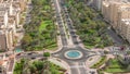 Traffic on a road intersection with roundabout in Barsha Heights and Greens district aerial timelapse.