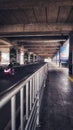 traffic road under a commuter rail bridge in a city