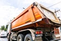 Traffic with road view through car front window, Dirty Schmitz Cargobull tipper trailer truck in traffic. Bucharest, Romania, 2020