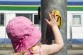 Traffic rules on the street for pedestrians.Children. The little girl at the traffic light presses the button. Hot sunny day