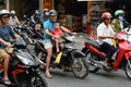 Motorbike rider with little child in front of bike at rush hour in the streets of Ho Chi Minh City, formerly Saigon, Vietnam Royalty Free Stock Photo