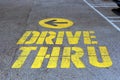 Drive thru traffic sign painted on yellow asphalt