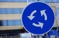 Traffic sign circulation site, white arrows on blue background Royalty Free Stock Photo