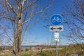 Traffic sign: cycle lane in both directions, blue and white round plate, cycle routes 4 and 13 Royalty Free Stock Photo