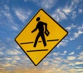 Traffic sign with graphic of a person crossing a street with a bible floating on a blue sky with clouds Royalty Free Stock Photo