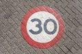 A traffic sign of 30km/h speed limit zone sign on a street