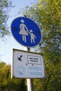 Traffic sign, sign, mother with child, pedestrian zone and the English words: no dog toilet, leash forced Royalty Free Stock Photo