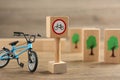 Traffic sign No cycling and toy bicycle on wooden table. Passing driving license exam Royalty Free Stock Photo