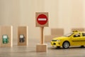 Traffic sign No entry and toy taxi car on wooden table. Passing driving license exam Royalty Free Stock Photo